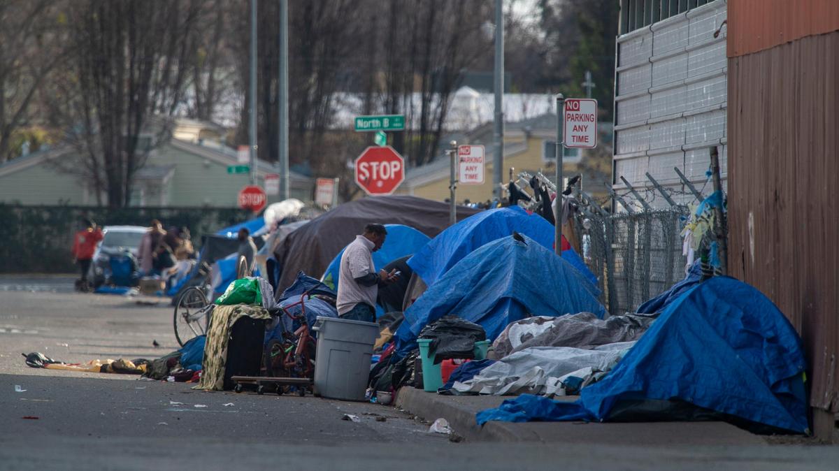 People experiencing homelessness camp along Ahern Street near North B Street, Friday, February 7, 2019, where a homeless man was found deceased on Tuesday as temperatures dropped to the low 30s, causing homeless activists to question why local officials have not opened warming centers.