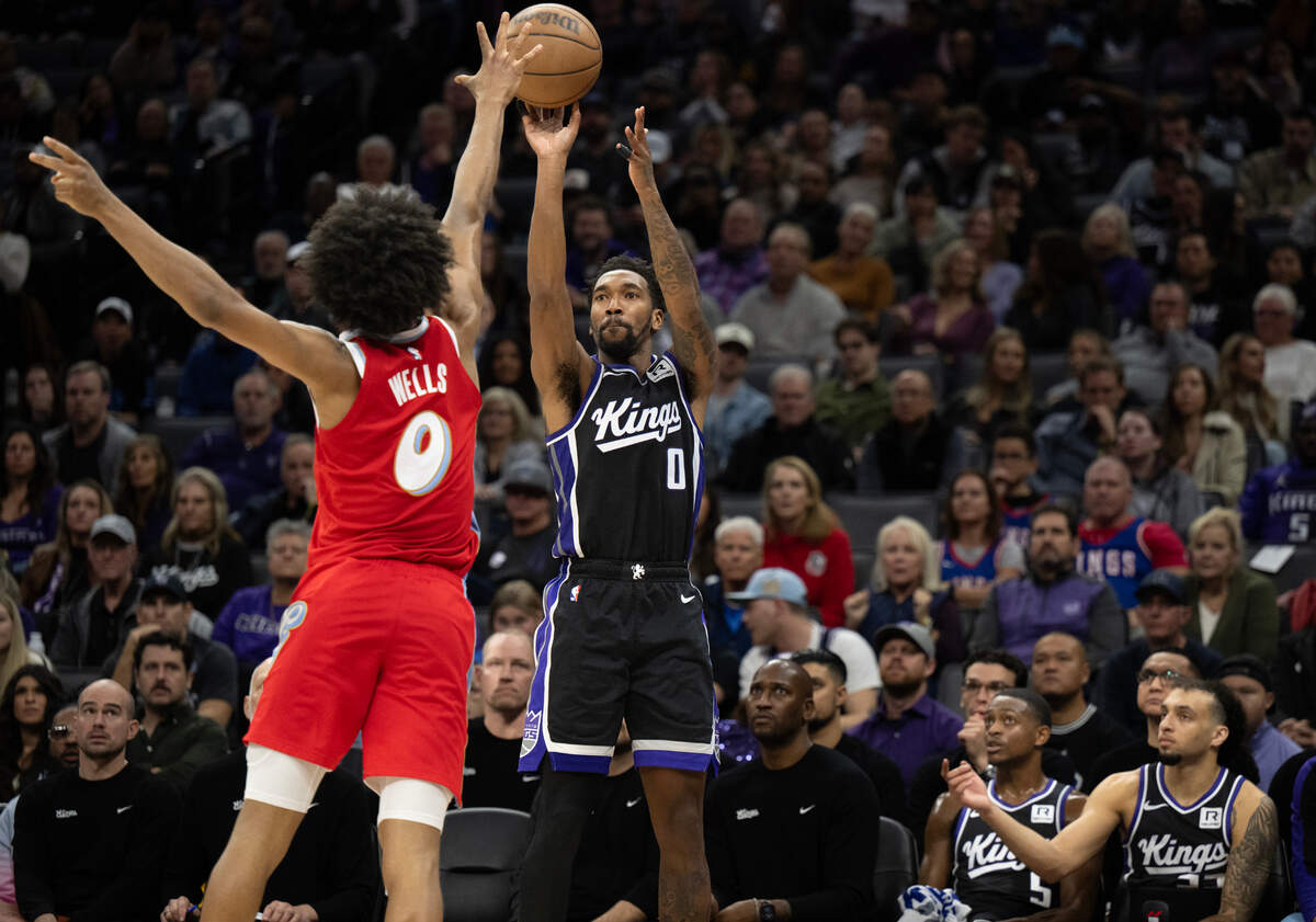 Sacramento Kings guard Malik Monk (0) makes a three-point shot over Memphis Grizzlies forward Jaylen Wells (0) in the second half Friday at Golden 1 Center.
