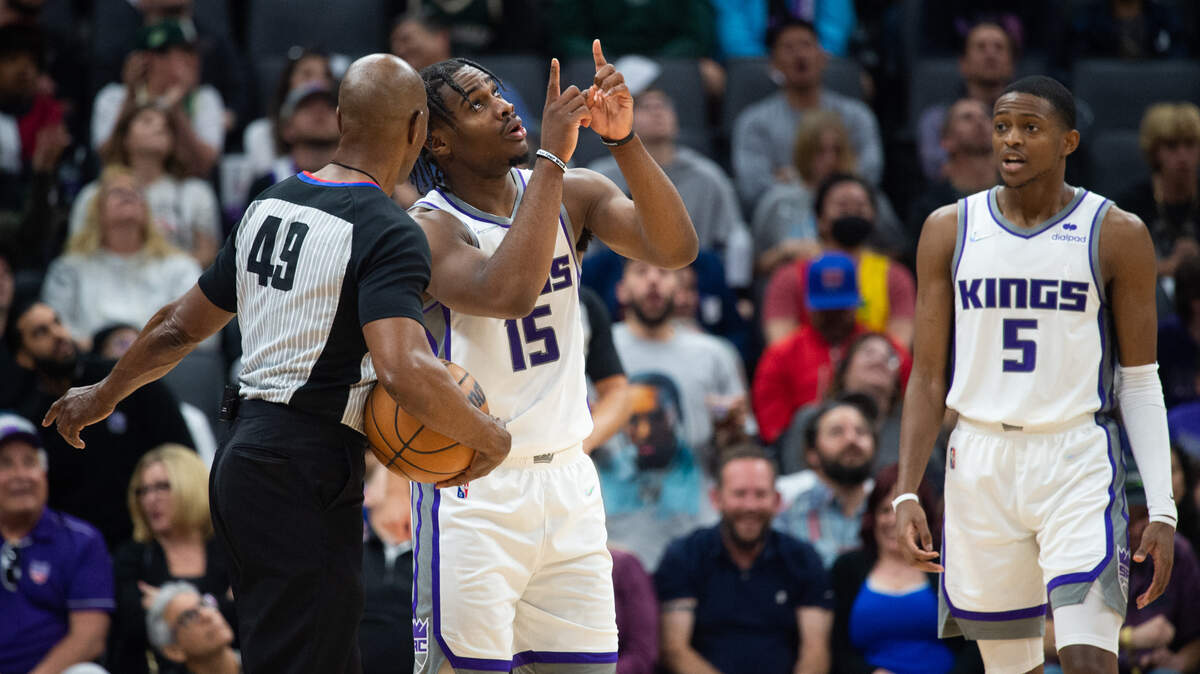 Sacramento Kings guard Davion Mitchell (15) talks with official Tom Washington about a penalty called on him during a game against the Milwaukee Bucks at the Golden 1 Center in Sacramento, Wednesday, March 16, 2022.