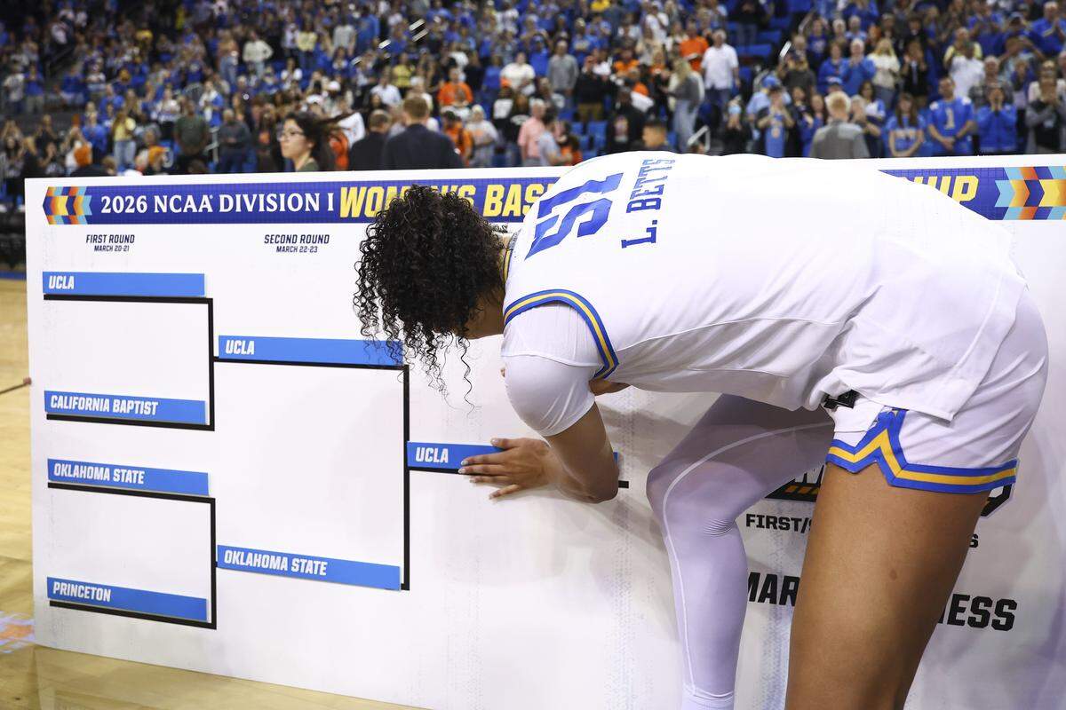 LOS ANGELES, CALIFORNIA - MARCH 23: Lauren Betts #51 of the UCLA Bruins adds the team to the division bracket after winning the second round game of the 2026 NCAA Women's Basketball Tournament against the Oklahoma State Cowgirls at UCLA Pauley Pavilion on March 23, 2026 in Los Angeles, California. (Photo by Melina Pizano/Getty Images)