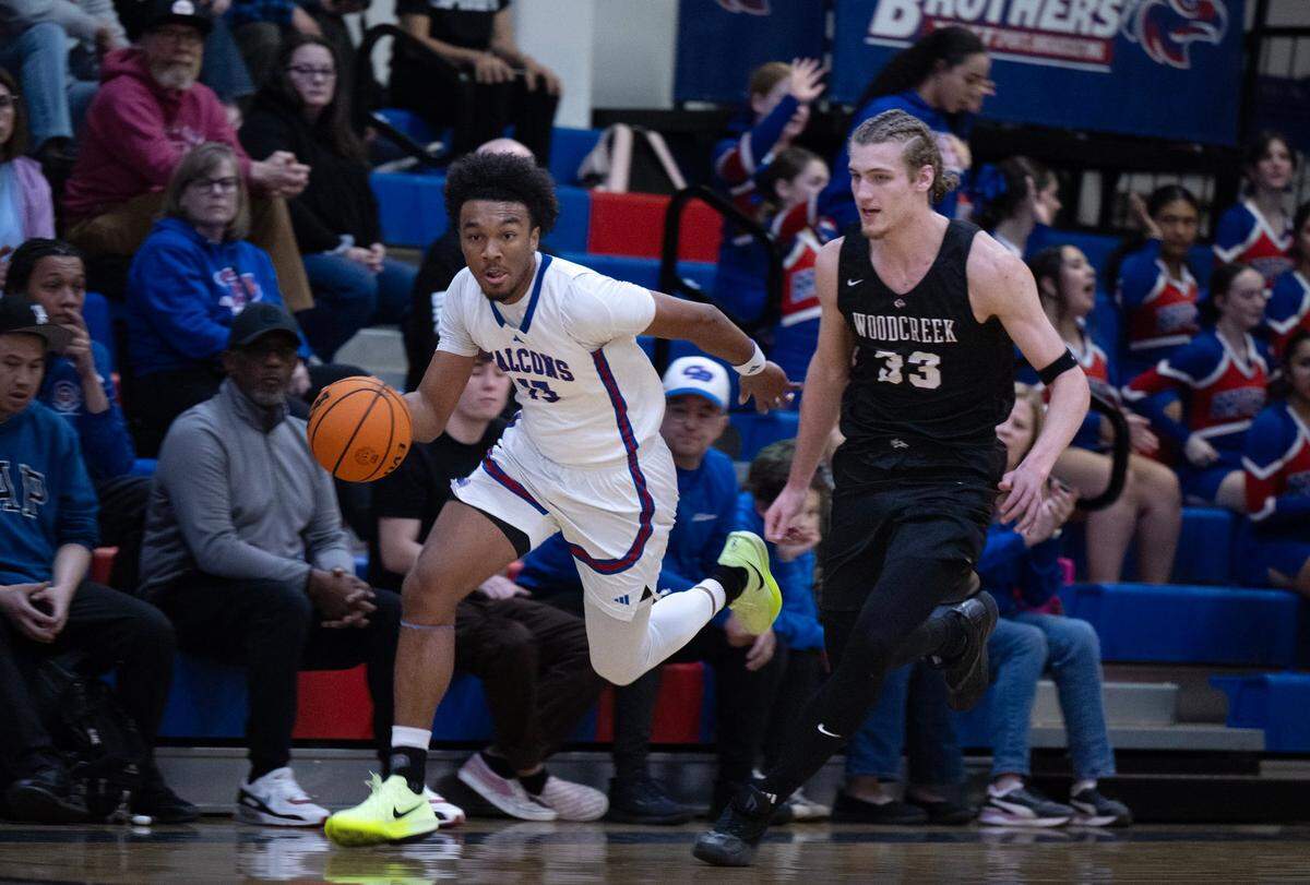 The Christian Brothers Falcons’ Stephan Hewitt (13) dribbles past the Woodcreek Timberwolves’ Max VanLaningham (33) in January.