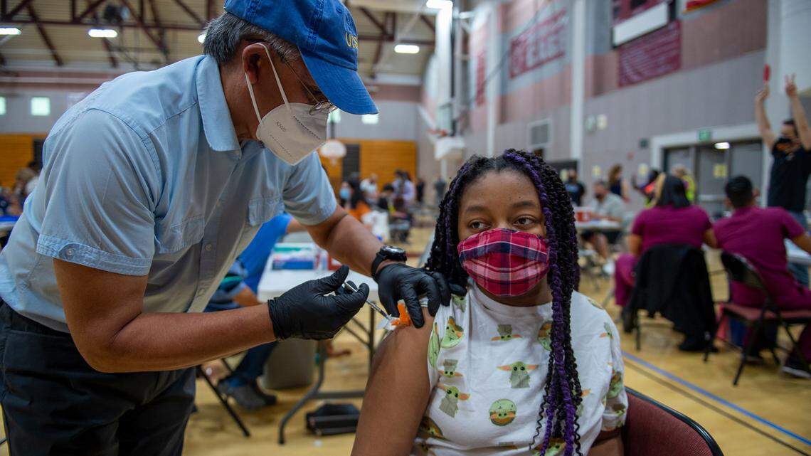 Lauren Burks, 13, gets her first dose of the Pfizer-BioNTech COVID-19 vaccine by Alan Rabe, D.D.S. during a vaccine clinic Saturday May 15, 2021 at Natomas High School. The U.S. Centers for Disease Control and Prevention approved the Pfizer shot for use in children ages 12 to 15.