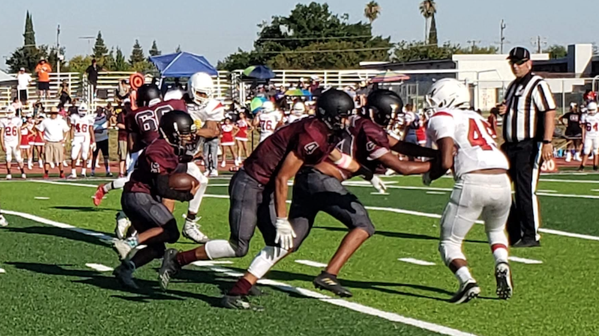 Hiram Johnson’s Floyd Kennedy carries the ball against McClatchy during the Warriors’ 24-14 win Friday night.