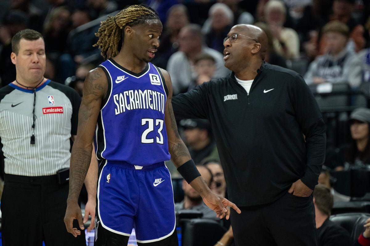 Sacramento Kings coach Mike Brown talks with guard Keon Ellis at Golden 1 Center on Nov. 24. Brown was fired on Dec. 27.