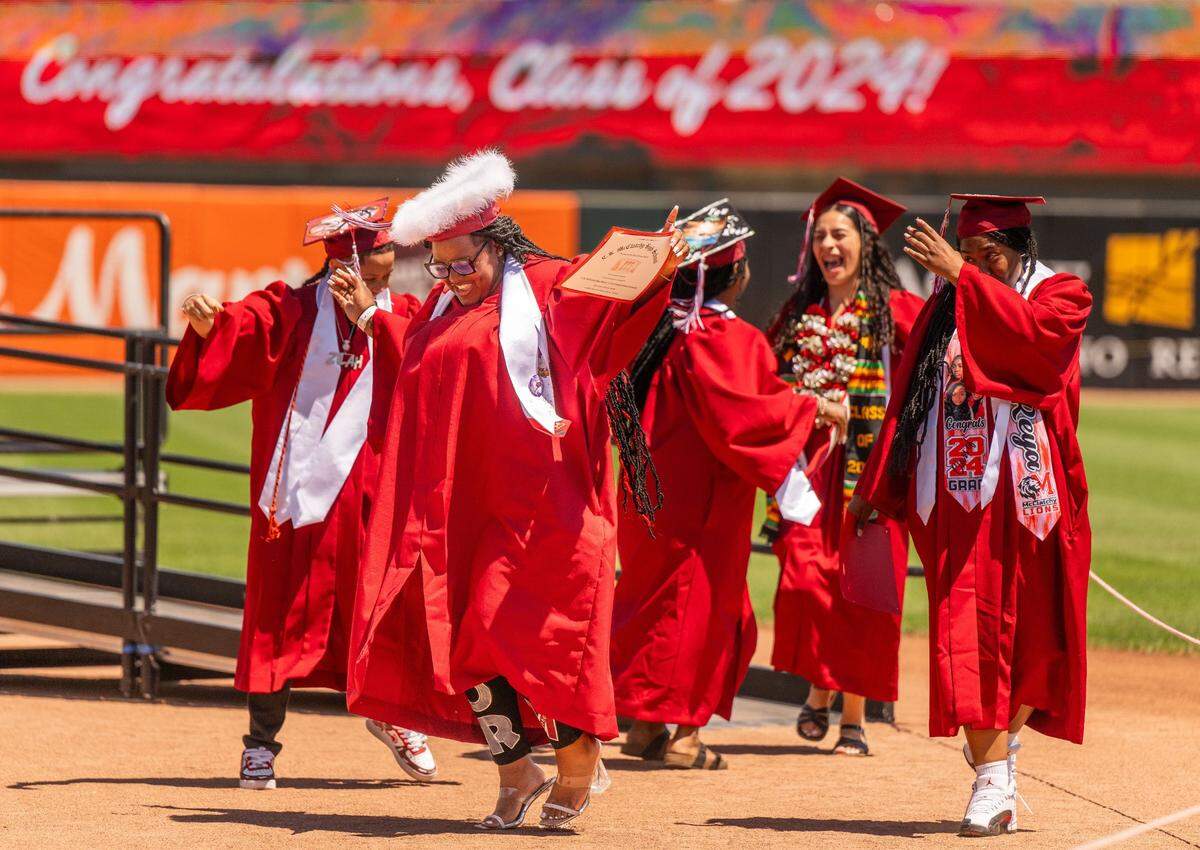 Amiyah Washington leads her friends in dance as C.K. McClatchy has its commencement ceremony on Tuesday at Sutter Health Park in West Sacramento.