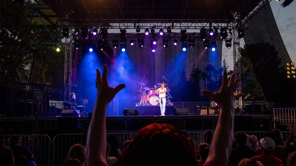 Fans dance, cheer and sing along as Queen Nation, a Queen tribute band, performs on the Golden 1 Stage during the California State Fair at Cal Expo on Tuesday, July 26, 2022, in Sacramento. Gregory Finsley, center, pays homage to Queen frontman Freddie Mercury.