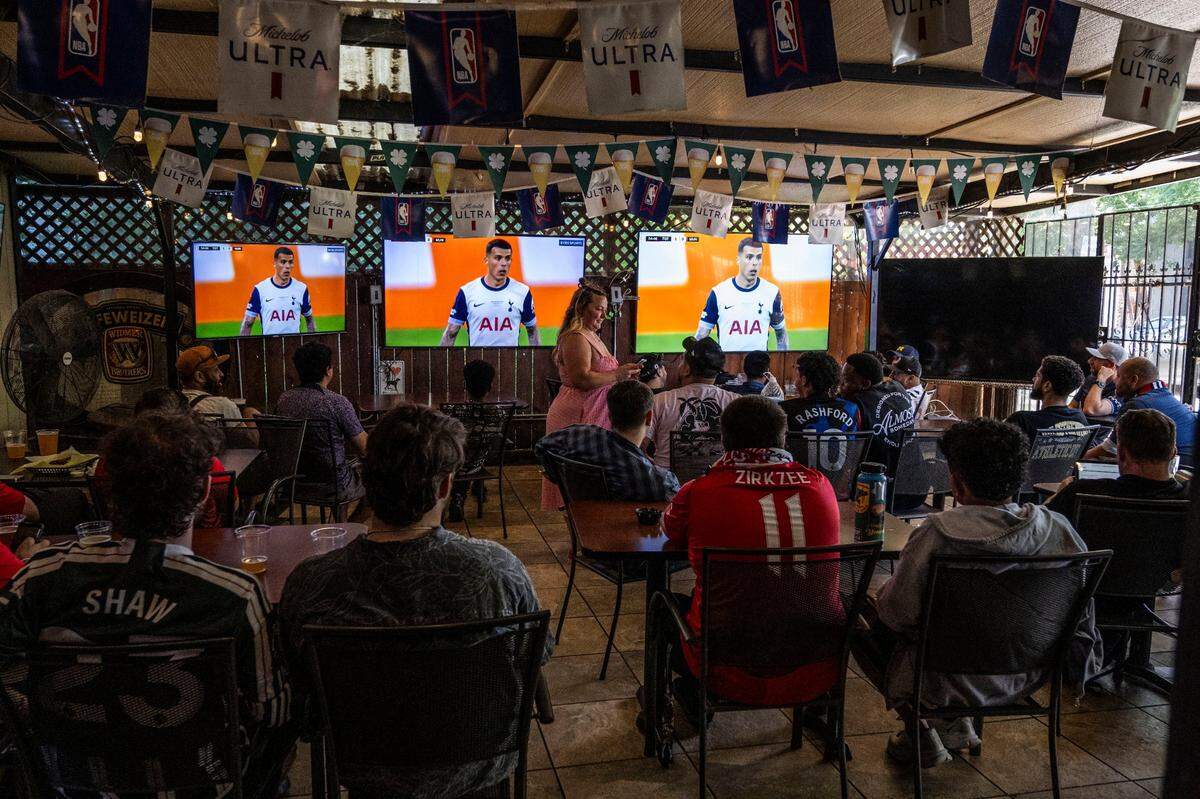 Fans watch the broadcast of the Europa League final between Tottenham and Manchester United on Wednesday at the Zebra Club in Sacramento.