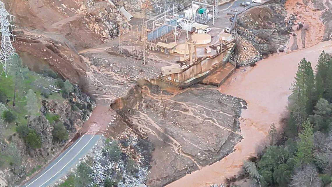 An aerial view shows muddy water and debris surrounding the New Colgate Powerhouse along the Yuba River south of Dobbins on Friday, Feb. 13, 2026, after a penstock pipe burst at the facility. Authorities rescued a group of workers and located one missing worker following the pipe break, according to the Yuba Water Agency and Cal Fire.