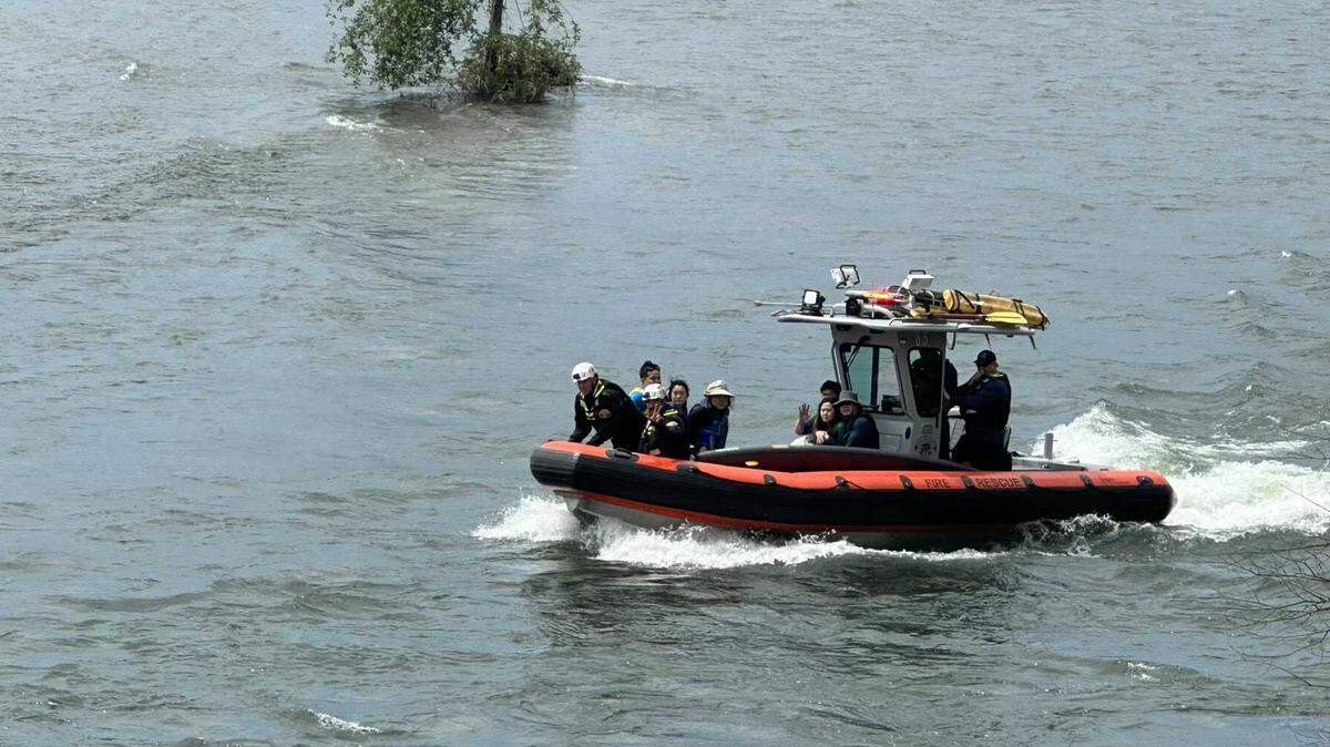 The Sacramento Metro Fire Department rescues six people who fell from their paddle boards from the American River near Carmichael on Sunday, May 28, 2023.
