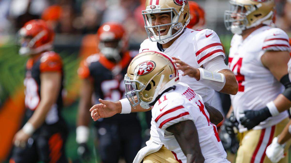 San Francisco 49ers quarterback Jimmy Garoppolo, above, celebrates after wide receiver Marquise Goodwin, below, scores a touchdown during the first half an NFL football game against the Cincinnati Bengals, Sunday, Sept. 15, 2019, in Cincinnati. (AP Photo/Gary Landers)