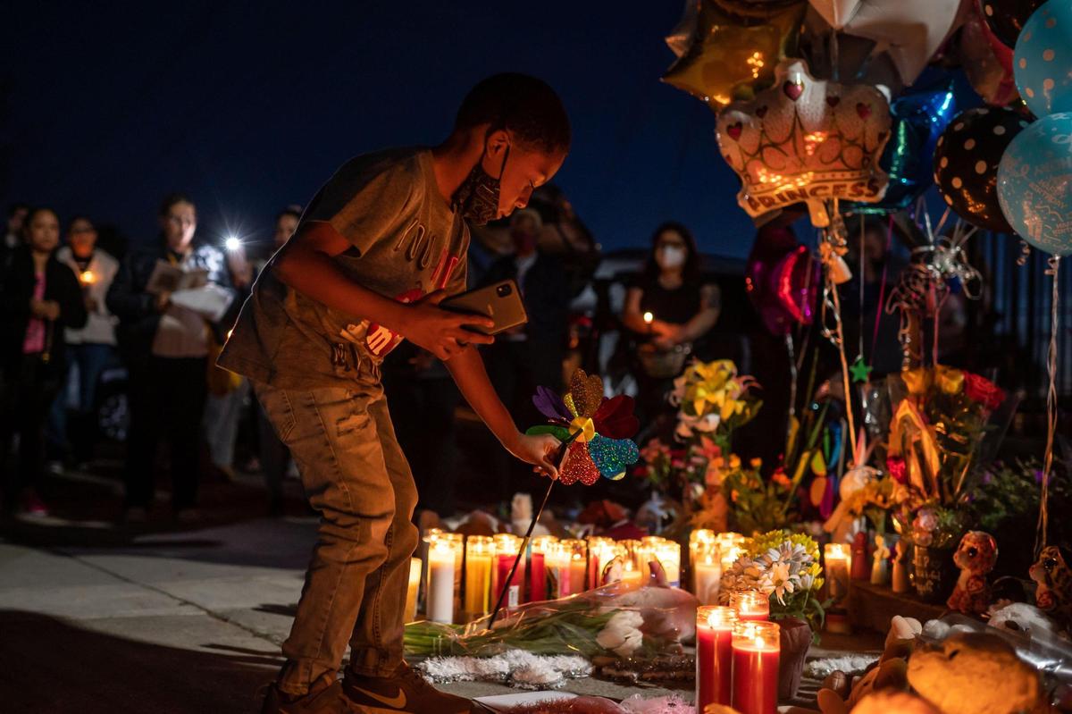Miles Manion, 6, places a pinwheel down at a makeshift memorial for Samia Mora Gutierrez,13, Samantha Mora Gutierrez, 10, and Samarah Mora Gutierrez, 9, during a vigil Tuesday, March 1, 2022, outside Arden Arcade’s The Church in Sacramento. “I’ve been praying all night, every day (for them),” Manion said, adding that he will never stop.