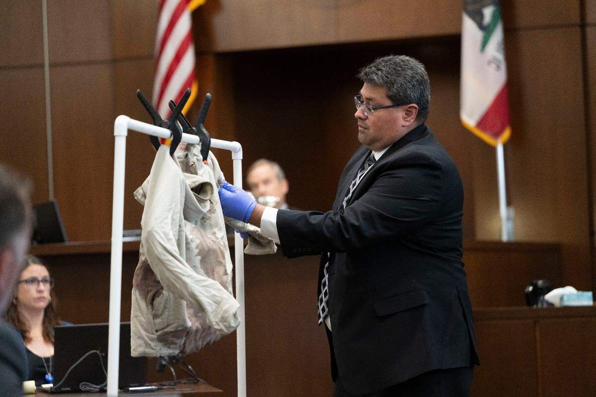 Davis Police Department detective Alex Torres describes the evidence of stabbings on a sweater, allegedly fatally stabbed by former UC Davis student Carlos Reales Dominguez, during the first day of trial at Yolo Superior Court in Woodland on Monday.