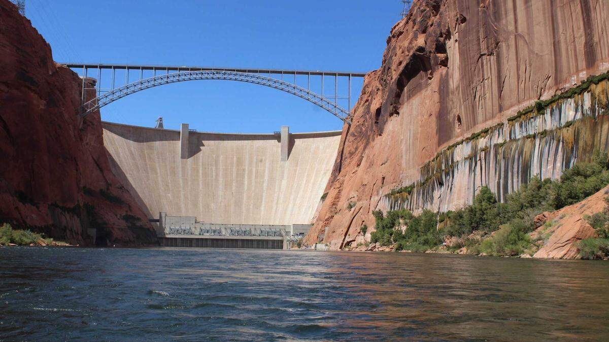 Glen Canyon Dam is seen Sept. 7 on the Colorado River upstream from Lees Ferry. The White House said cuts in water use pledged earlier this year by California, Arizona and Nevada are likely to ease the threat of reservoirs declining to perilous lows.