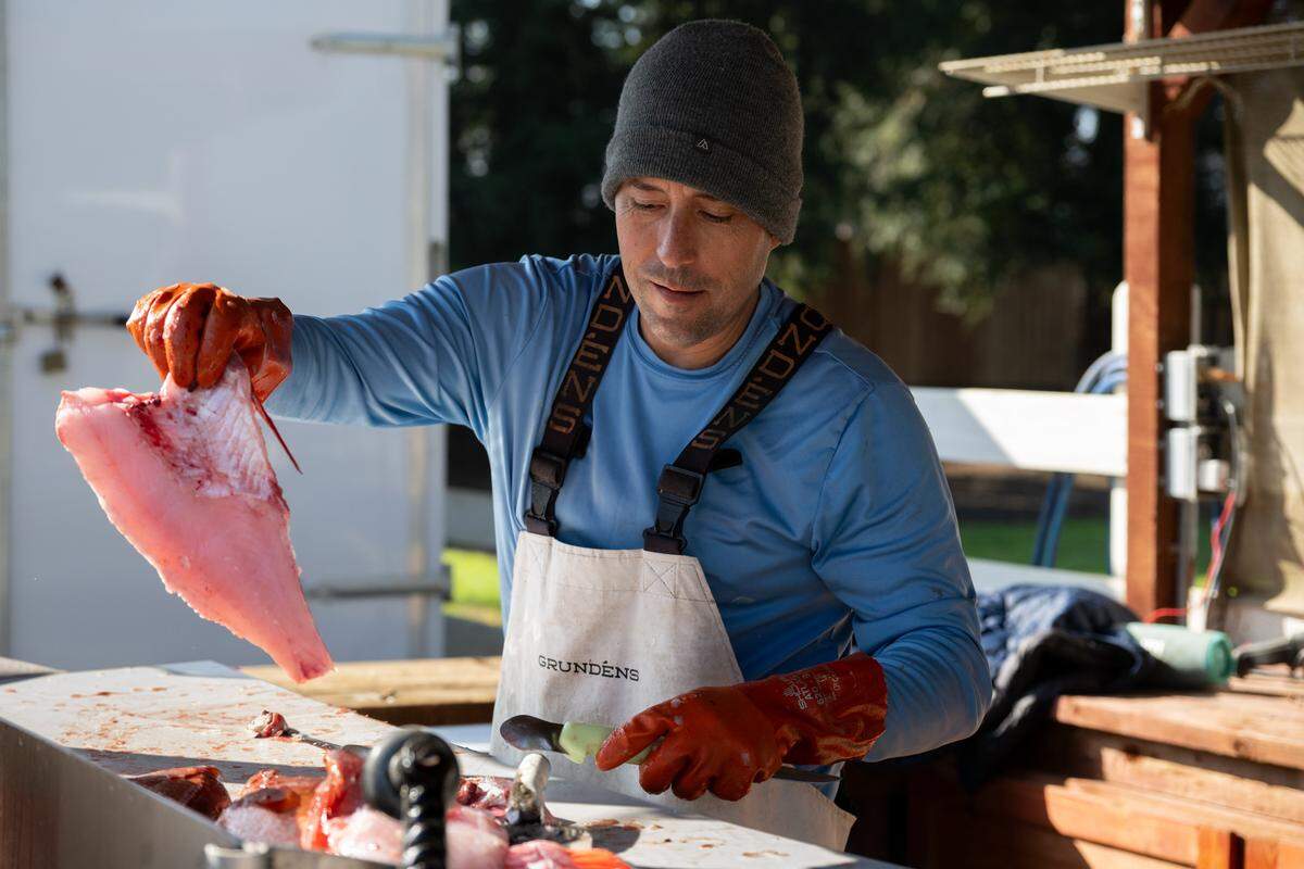 Anthony Ferrari fillets fresh red snapper for customers who select their fish to be prepared at Ferrari Fisheries on Jan. 14 in West Sacramento. Ferrari catches the fish off Fort Bragg from his commercial boat, selling most of his catch wholesale to restaurants in San Francisco and Sacramento, with about 10% sold locally at his stand.