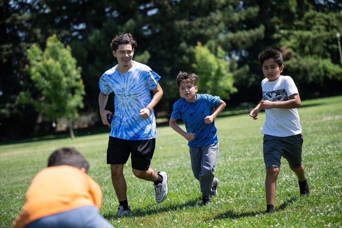 José Salazar plays soccer Monday at Niños Park with kids in The GreenHouse neighborhood program. “This is where I learned so many valuable social skills, and this is where I found my love for soccer,” said Salazar who graduated from the program this year and returned to work as a summer program staffer.