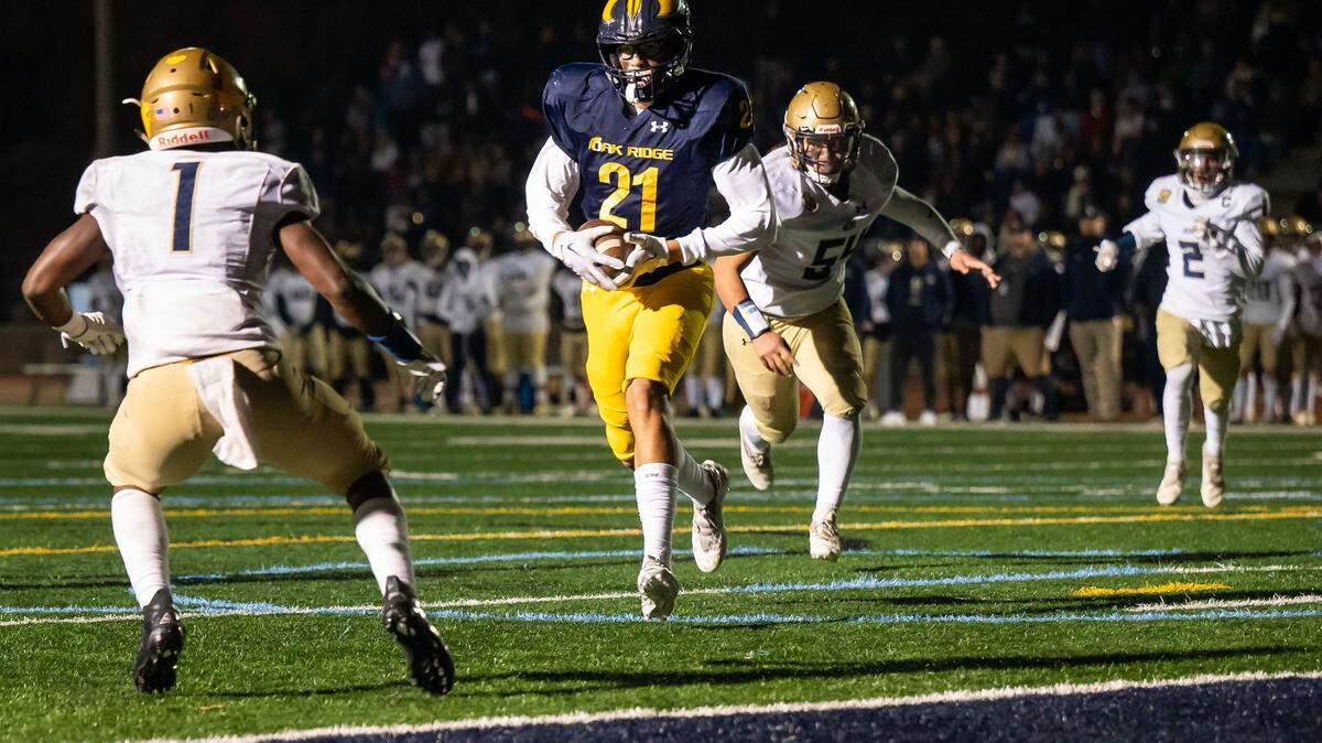 Oak Ridge Trojan tight end Kaleb Edwards (21) gets near the end zone on a reception as Elk Grove’s Wayshawn Parker (1) defends at left during the second quarter of the high school football CIF Sac-Joaquin Section playoff game Friday, Nov. 11, 2022, at Oak Ridge High School in El Dorado Hills.