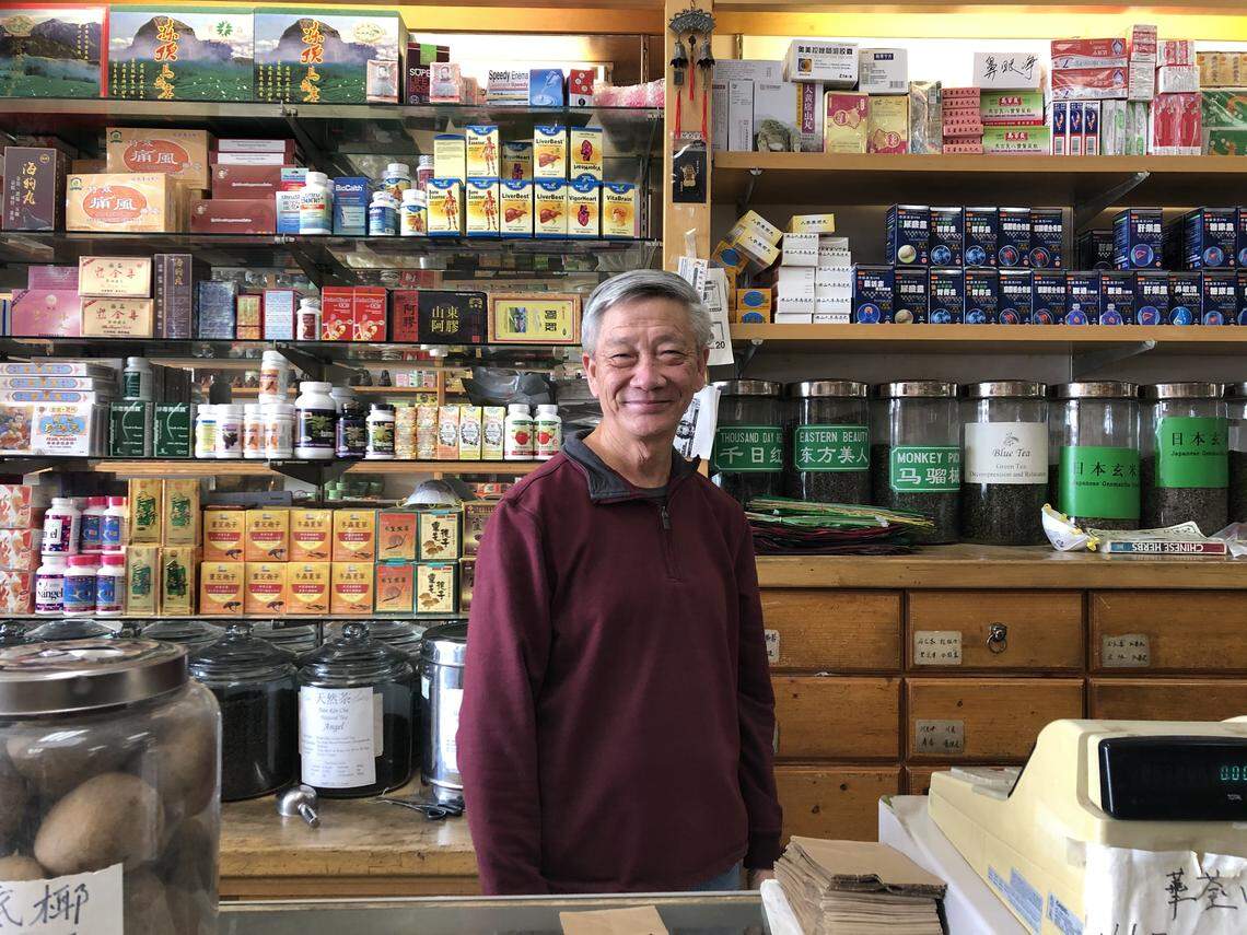 Savey Keo, a dispenser at Wah Tsun Chinese Herbs Co. in south Sacramento, tells his clients to wear a face mask just to be safe.