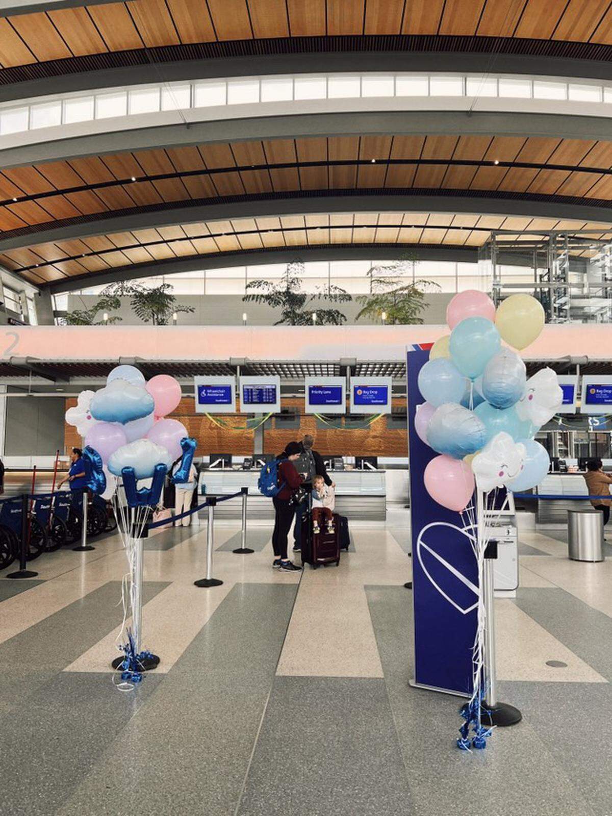 Passengers wait at a Southwest Airlines check-in counter at Sacramento International Airport on March 6, 2025, decorated to commemorate the airline’s inaugural nonstop flight from Sacramento to Baltimore/Washington International Thurgood Marshall Airport.