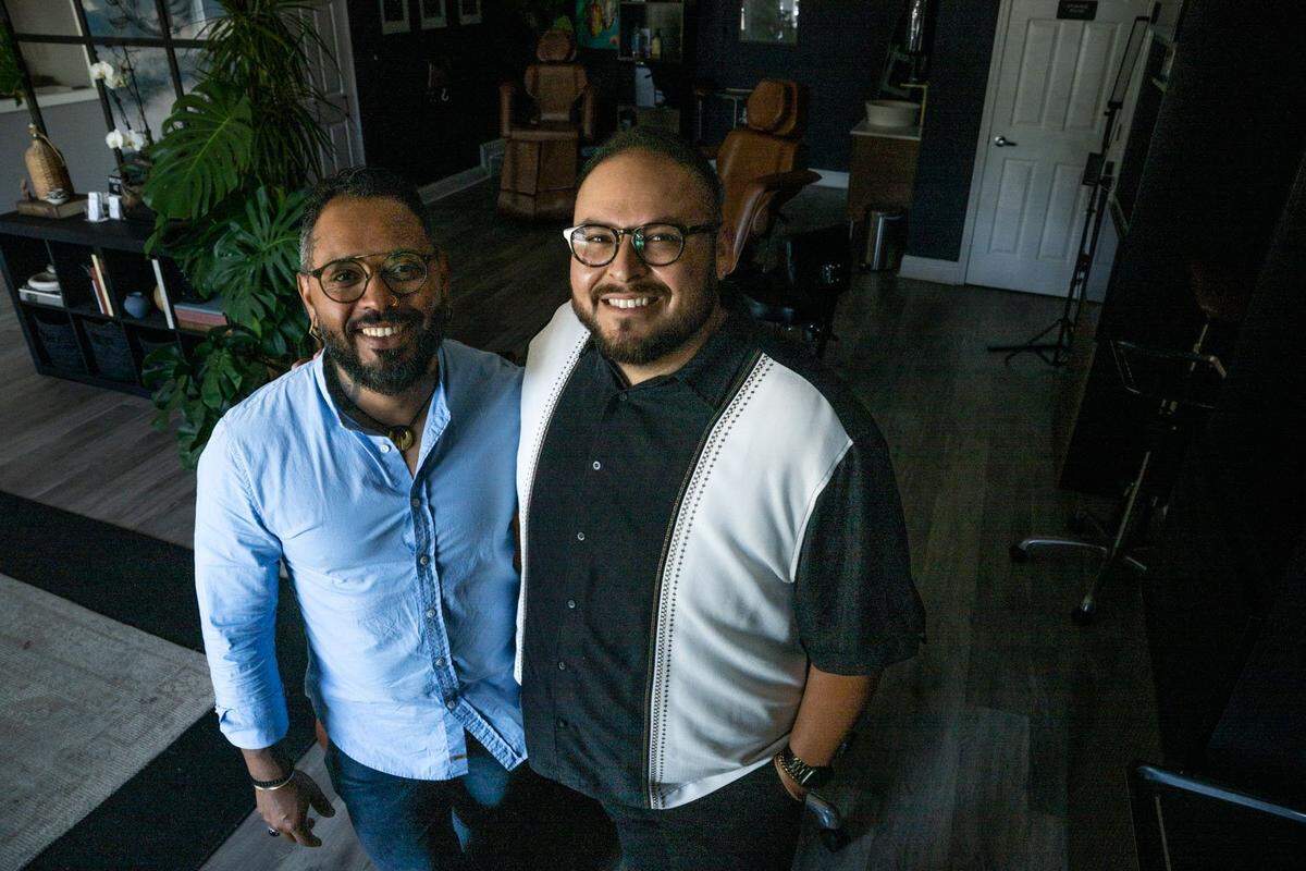 David Ramses Cabral and Gerardo Cabral stand in their tattoo studio Ghost Ink Company in Land Park on June 26. The business launched last year has quickly gained a reputation for being one of the few Latino, queer-owned tattoo studios in the country.