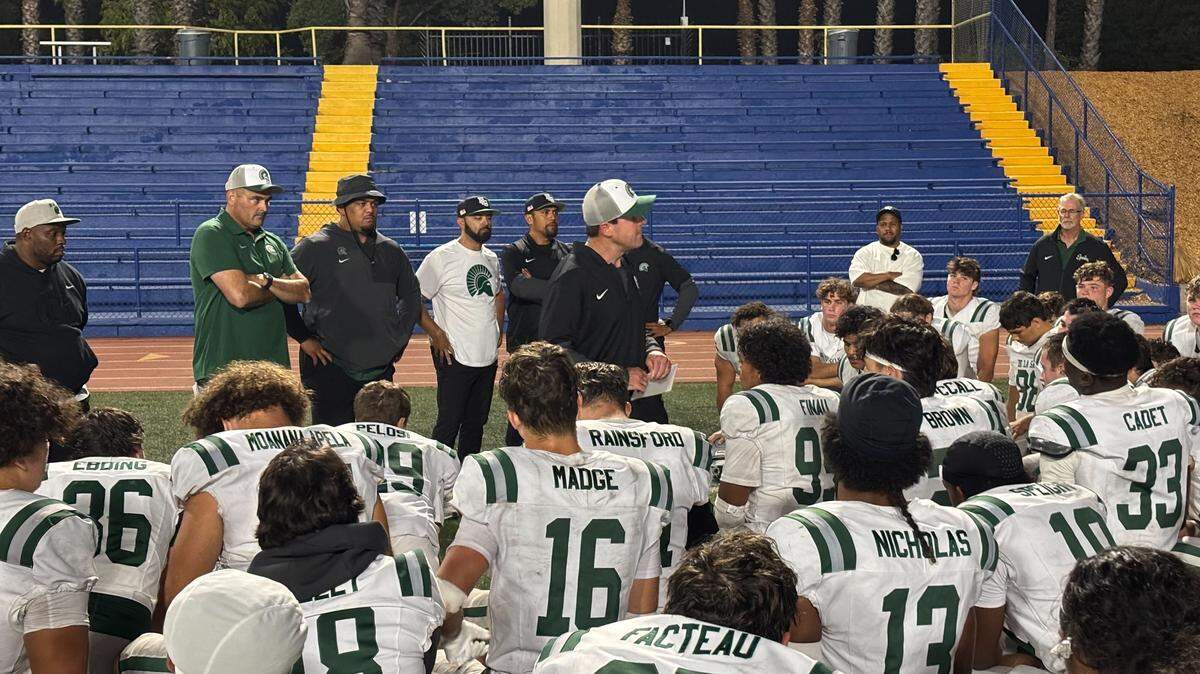 De La Salle Spartans coach Justin Alumbaugh speaks to his team after a 47-20 win Friday over the Grant Pacers in Sacramento.