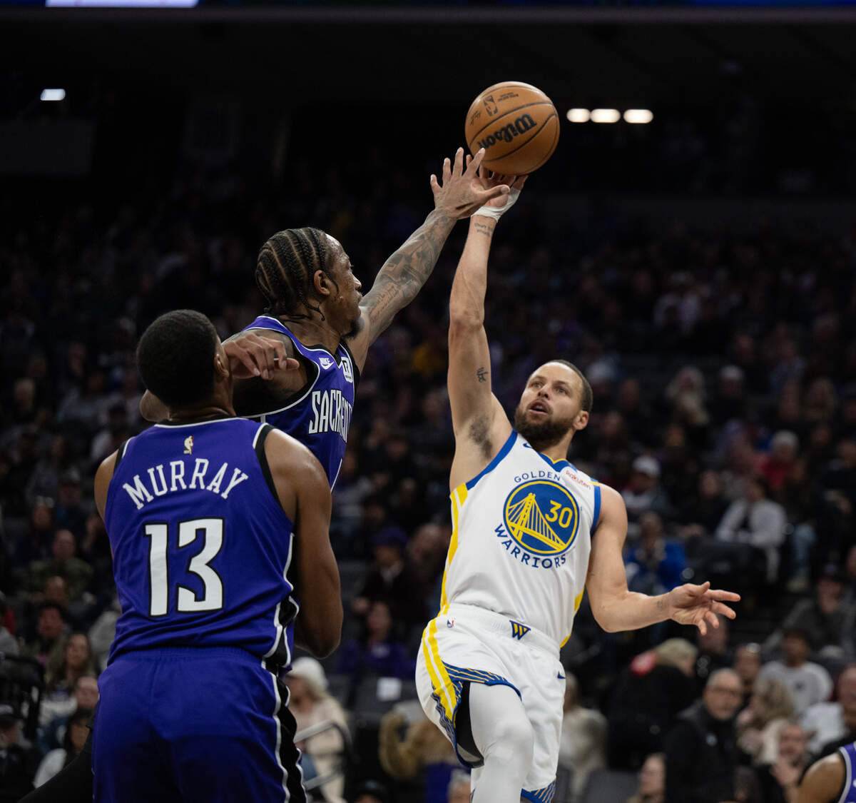 Golden State Warriors guard Stephen Curry (30) scores over Sacramento Kings forward DeMar DeRozan (10) in the first half on Wednesday at Golden 1 Center.