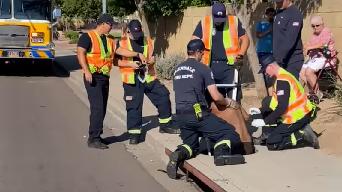 Fire officials used a ladder to rescue a man trapped in a storm drain in Glendale, Arizona, on Sept. 30, 2021. Low oxygen levels are a concern in confined spaces.