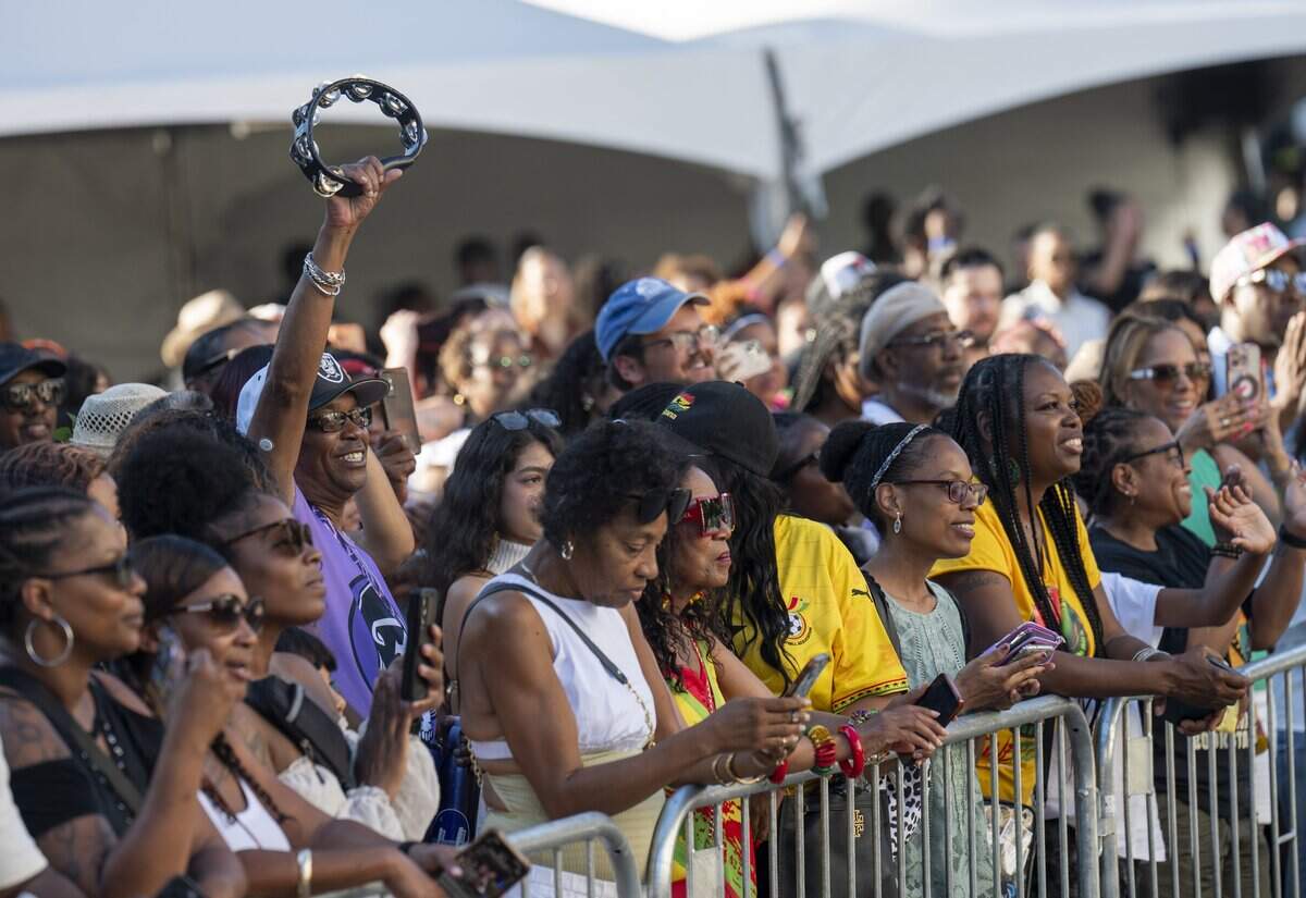 A concert attendee raises his tambourine in the air during singer Goapele’s performance at the California Capitol during the Juneteenth celebration hosted by the California Legislative Black Caucus on Wednesday, June 17, 2026.