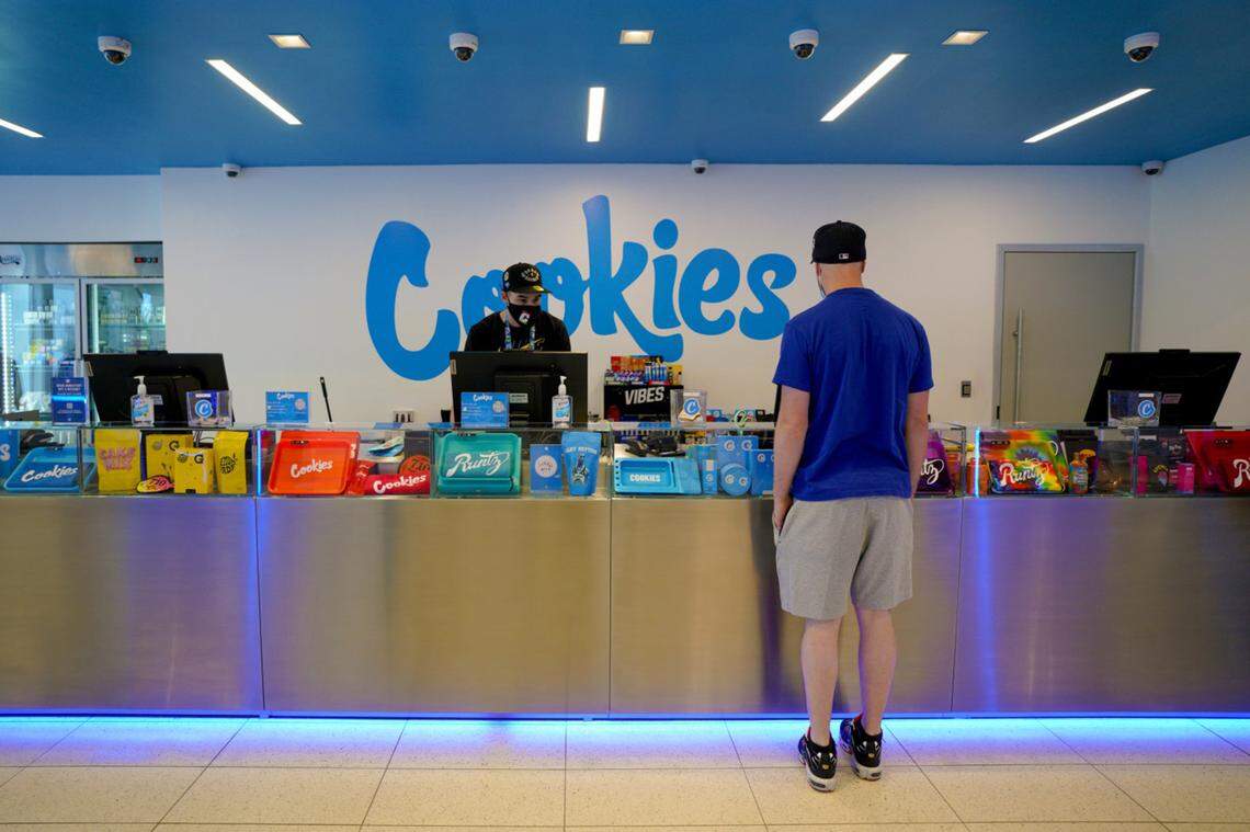 Shane Belfield assists a customer with his order on Thursday, Sept. 23, 2021, at Cookies dispensary in Mission Valley. The dispensary, which opened in May, is one of two Cookies dispensaries in San Diego County.