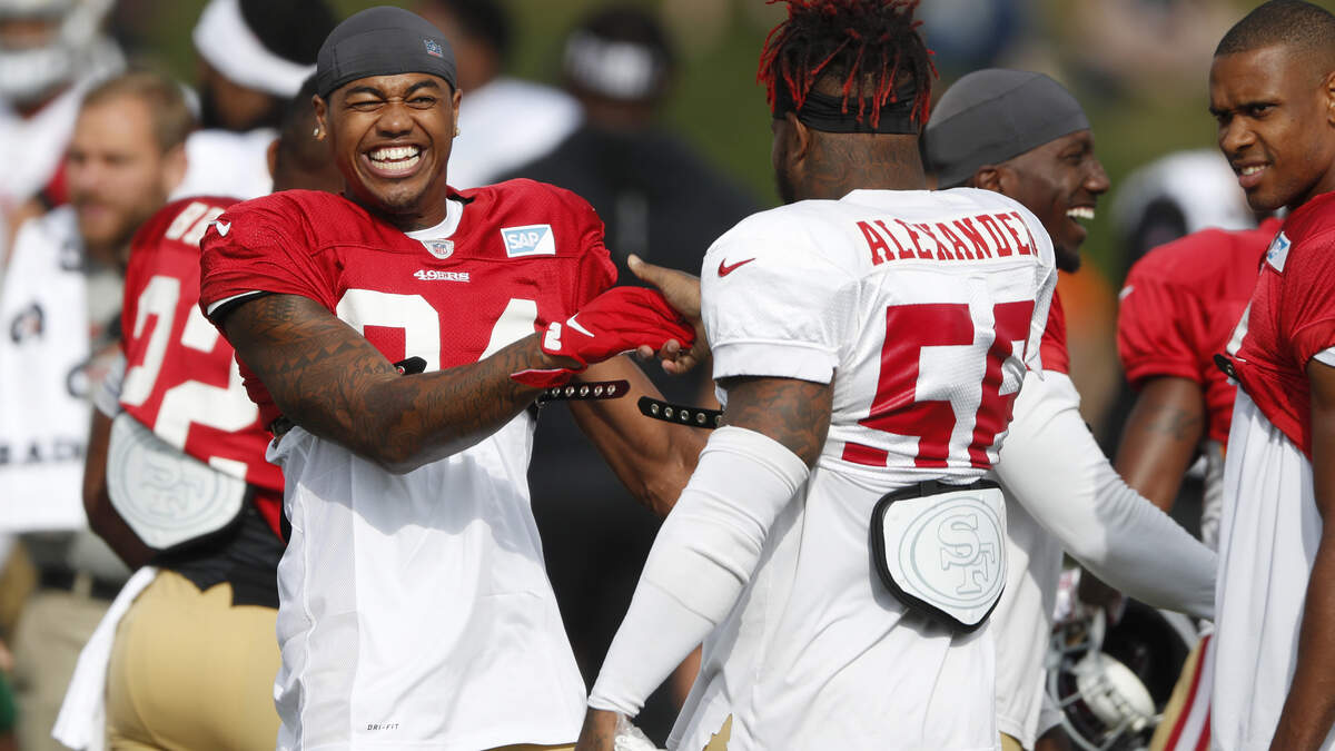 San Francisco receiver Kendrick Bourne, left, jokes with middle linebacker Kwon Alexander during a combined NFL football training camp with the Denver Broncos.