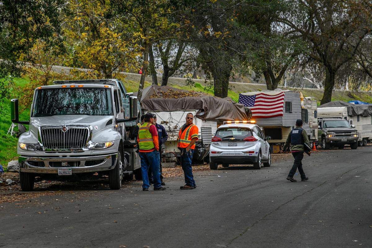 Sacramento city crews clear vehicles and trailers along Lathrop Way on Monday, Dec. 6, 2021.
