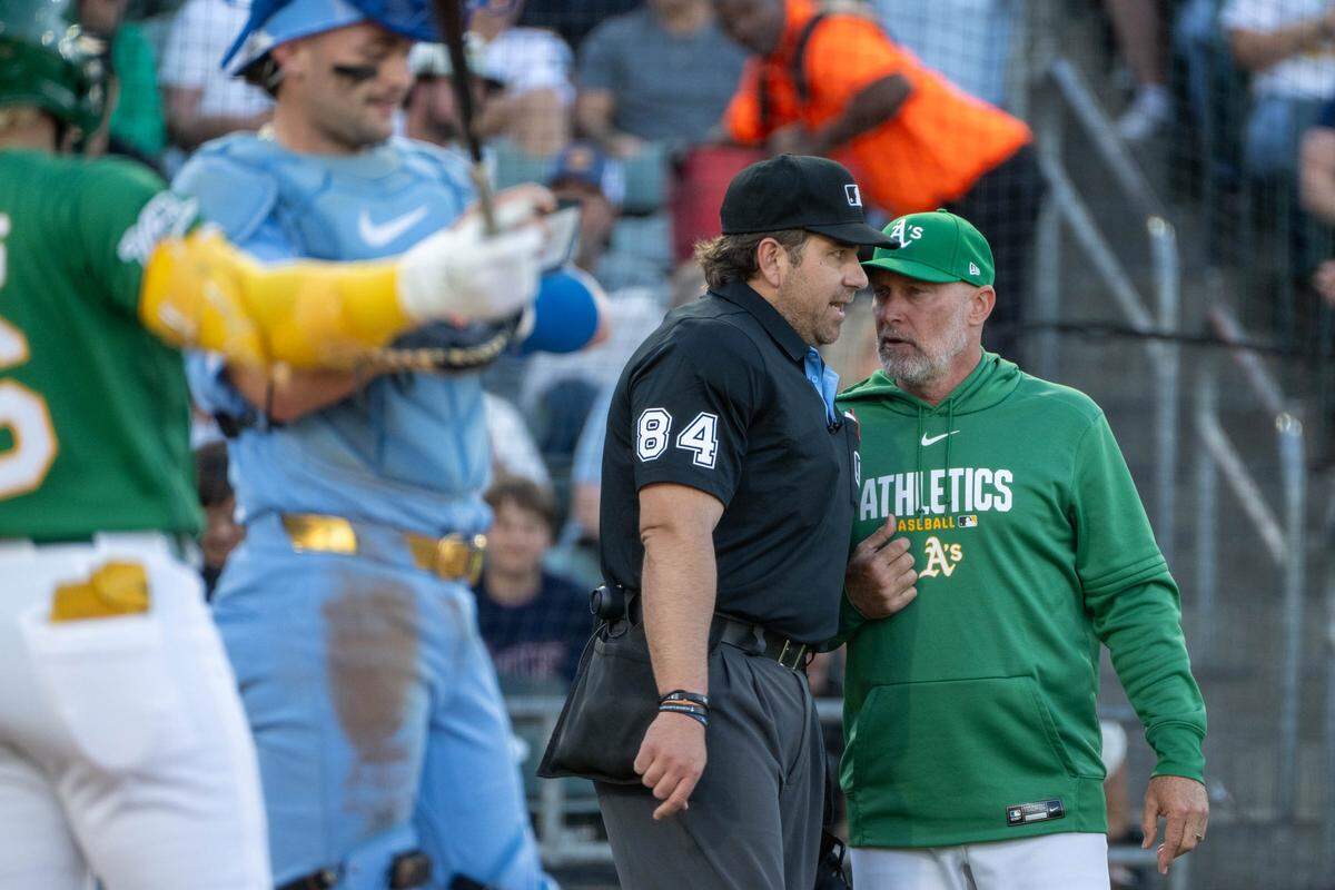 Home plate ump John Libka talks with Athletics manager Mark Kotsay (7) in the first inning during a game at Sutter Health Park in West Sacramento on Wednesday.
