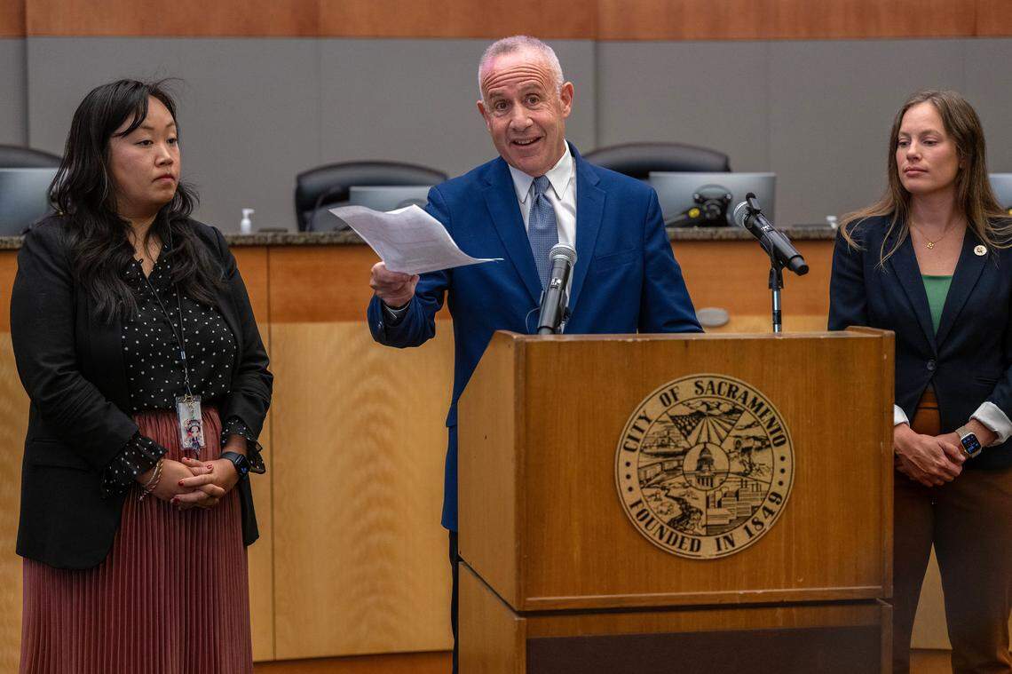 Sacramento Mayor Darrell Steinberg, alongside City Councilwomen Mai Vang, left, and Caity Maple, holds a July proposal to partner with District Attorney Thien Ho at a news conference on Tuesday, responding to a letter sent by Ho threatening to file charges against city officials if they don’t comply with a list of demands on the homeless issue.