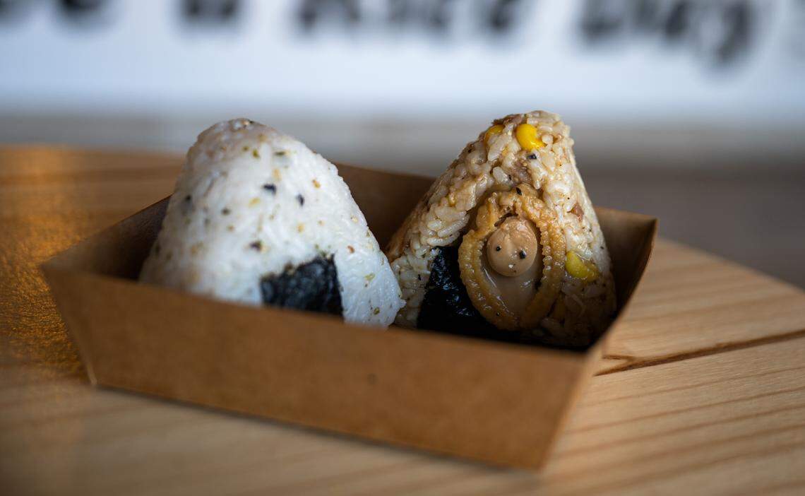 The smoked salmon with cream cheese onigiri ($4.50) left, and the abalone with truffle sauce onigiri ($8.88) are unwrapped and  ready to serve at Rice Theory on Freeport Boulevard in Sacramento last week.