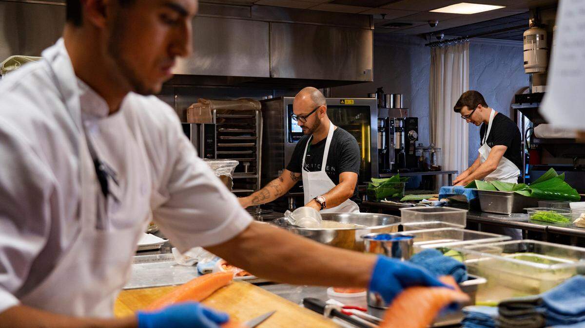 From left, sous chef Gio Sarmiento, sous chef Eddie Torres, and chef de partie Tim Katz prepare for dinner service at The Kitchen on June 5, 2019. The restaurant is one of two Michelin Star-rated restaurants in Sacramento.