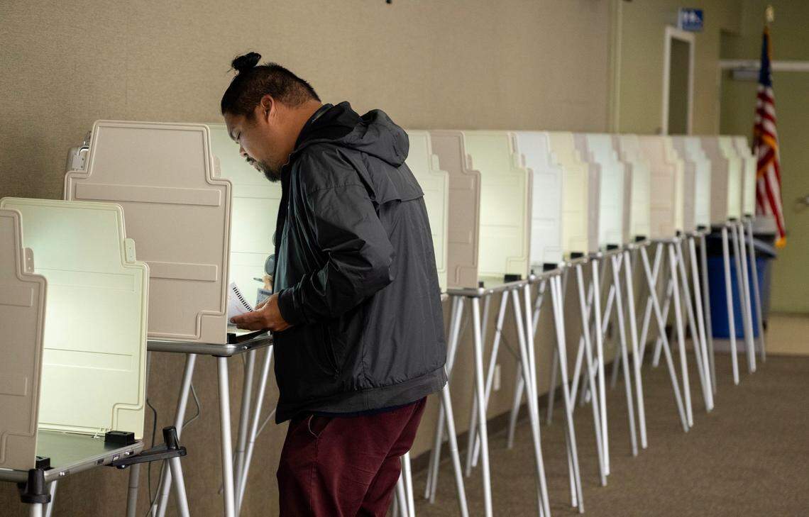 Justin Garon fills out his paper ballot on Monday, Nov. 4, 2024, at the Sierra 2 vote center on 24th Street in Sacramento’s Curtis Park neighborhood.