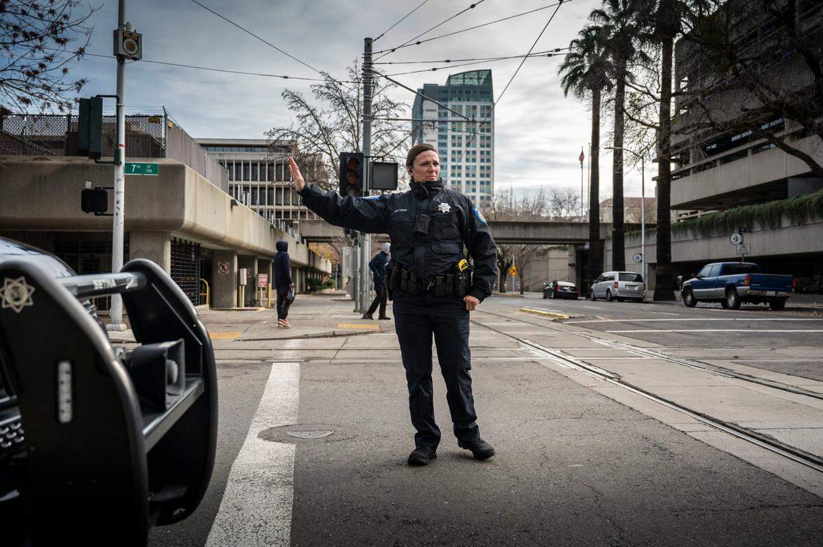A Sacramento Police officer controls traffic in downtown Sacramento after a SMUD substation fire on H Street in December.
