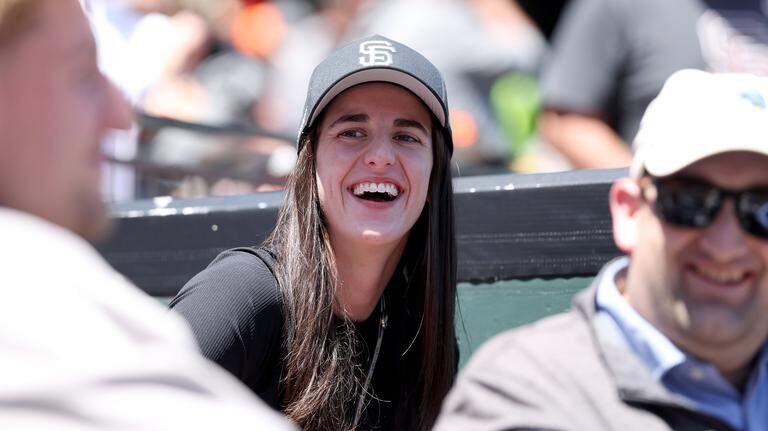 Wearing a Giants hat, WNBA star Caitlin Clark takes in a game in San Francisco
