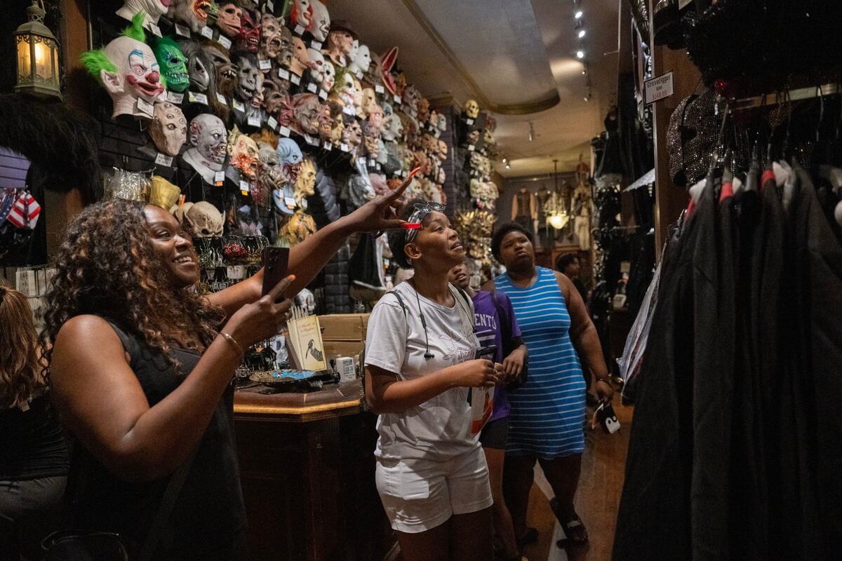 Briana Reynolds points at costumes displayed at Evangeline’s earlier this month in Old Sacramento.