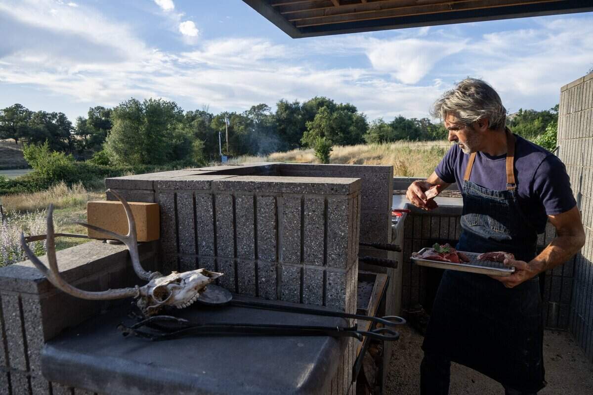 Chef Paul Ladeira grills steak at Blue Ruby Farm in Browns Valley earlier this month.