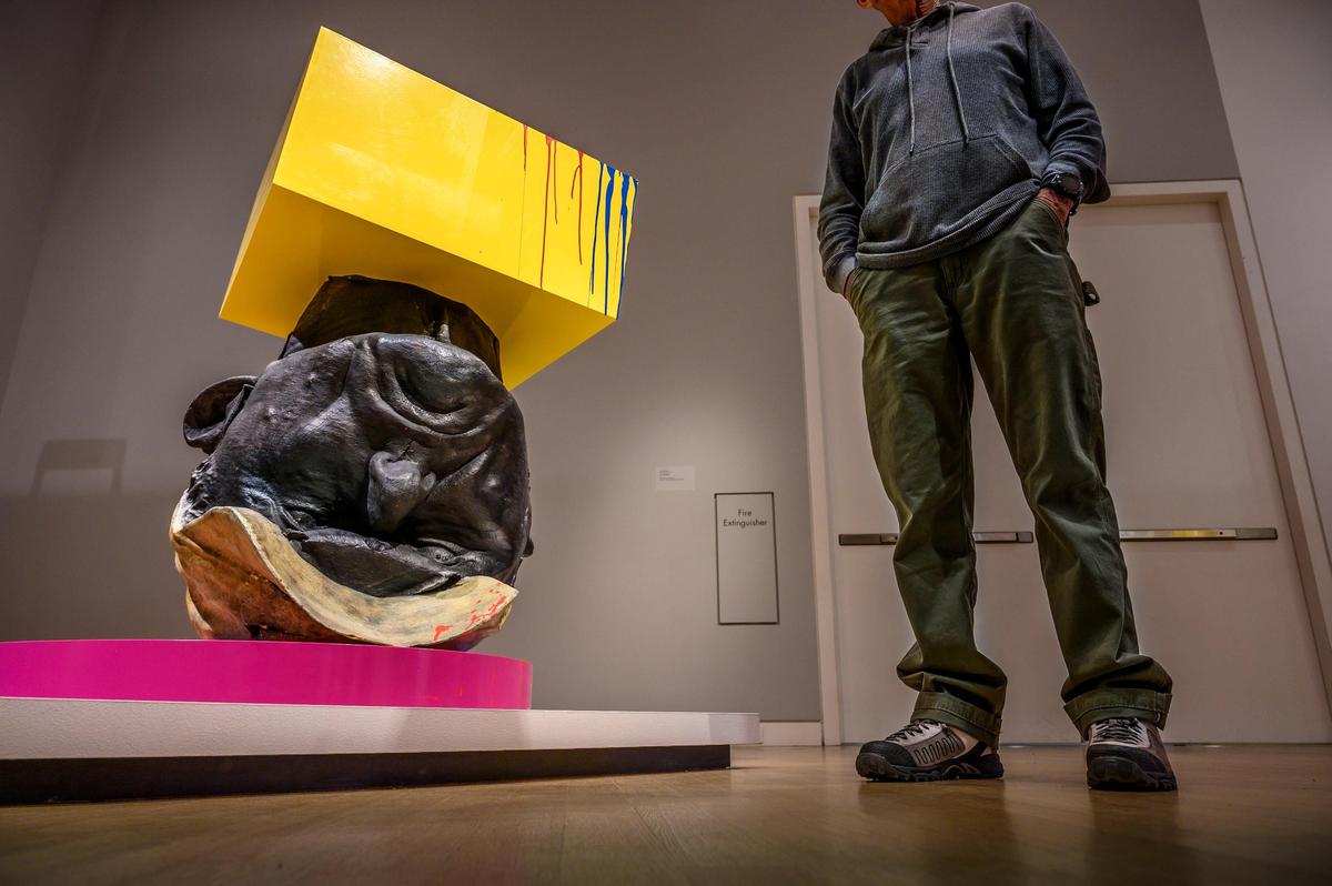 Sacramento native artist Richard Jackson stands next to “Self Portrait”, one of the pieces of his “Big Ideas” show at the Crocker Art Museum, on Friday, April 26, 2019. The piece is made of Steel, bronze, wood, paint.