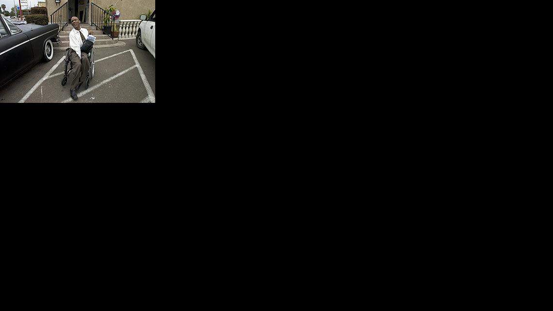 Attorney Theodore Pinnock sits outside a San Diego business in April that he sued for allegedly failing to provide disabled customers with the parking and access required by law. The San Diego attorney, who has cerebral palsy, says he has filed more than 2,000 suits since the late 1990s for violations of the Americans With Disabilities Act.