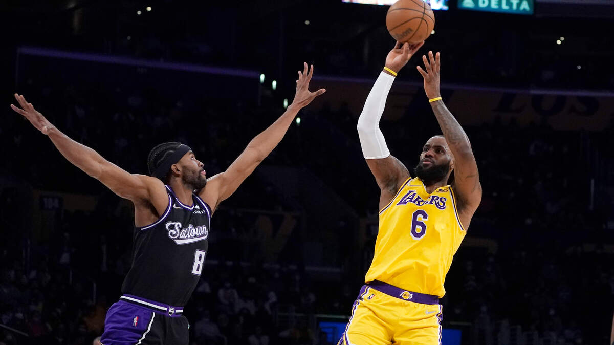 Los Angeles Lakers forward LeBron James (6) shoots over Sacramento Kings forward Maurice Harkless (8) during the first half of an NBA basketball game Tuesday, Jan. 4, 2022, in Los Angeles. (AP Photo/Marcio Jose Sanchez)