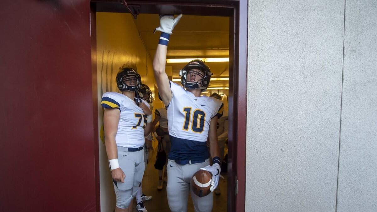 Oak Ridge Trojans Justin Lamson (10) and Brandon Summers (75) come out of the locker room before the game at Del Oro on Oct. 5.