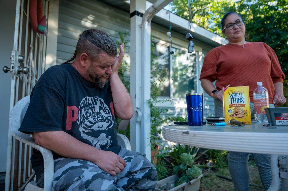Seth Jordan wipes tears on Aug. 21, 2024 while grieving for his son Shawn Jordan, who died after being hit by a vehicle on Walerga Road in June. His fiancee Aubrey Fong, who helped raise Shawn, stands at right. Seth was hospitalized for pancreatitis in August. He said he almost drank himself to death after the loss of his son.