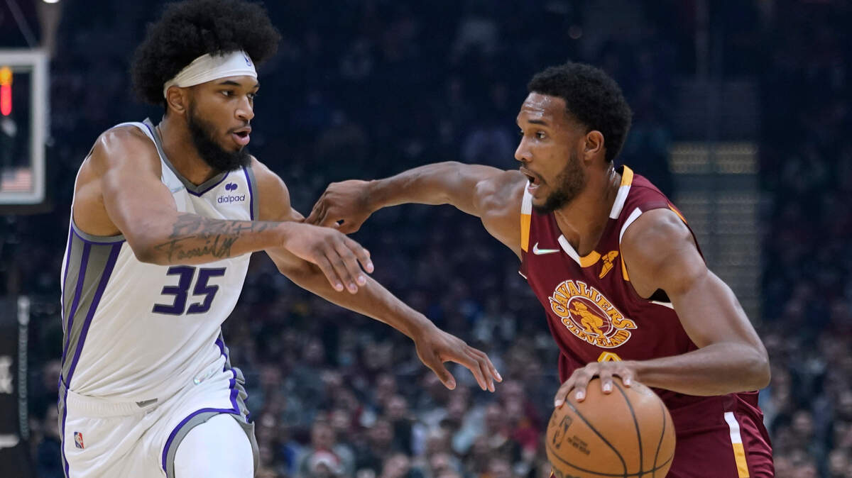 Cleveland Cavaliers’ Evan Mobley, right, drives against Sacramento Kings’ Marvin Bagley III during the first half of an NBA basketball game Saturday, Dec. 11, 2021, in Cleveland. (AP Photo/Tony Dejak)