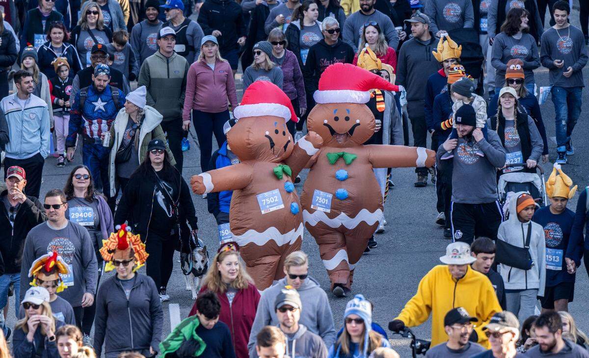 Participants of the 30th annual Run to Feed the Hungry run in their gingerbread blow-up costumes in East Sacramento n Thursday, Nov. 23, 2023,