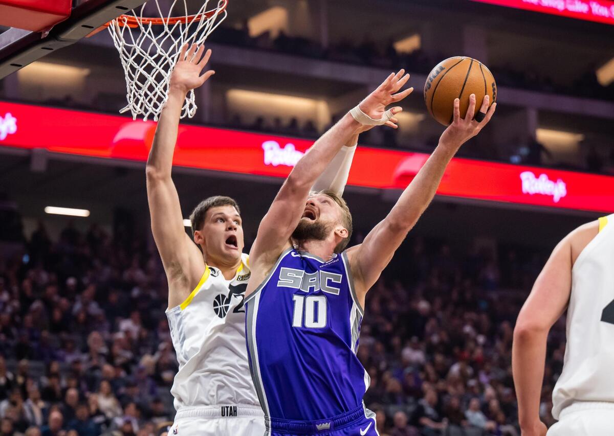 Sacramento Kings center Domantas Sabonis (10), right, is fouled by Utah Jazz center Walker Kessler (24) on his way up for a shot during the first quarter at the NBA basketball game Saturday, March 25, 2023, at Golden 1 Center.