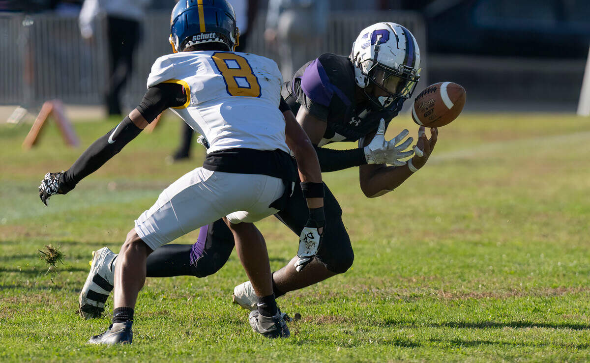 The Sacramento Dragons’ Robert Hamel (1) makes a catch in the flat as the Del Campo Cougars’ Isaiah Richmond (8) defends in a Sac-Joaquin Section first-round playoff game in 2024. 