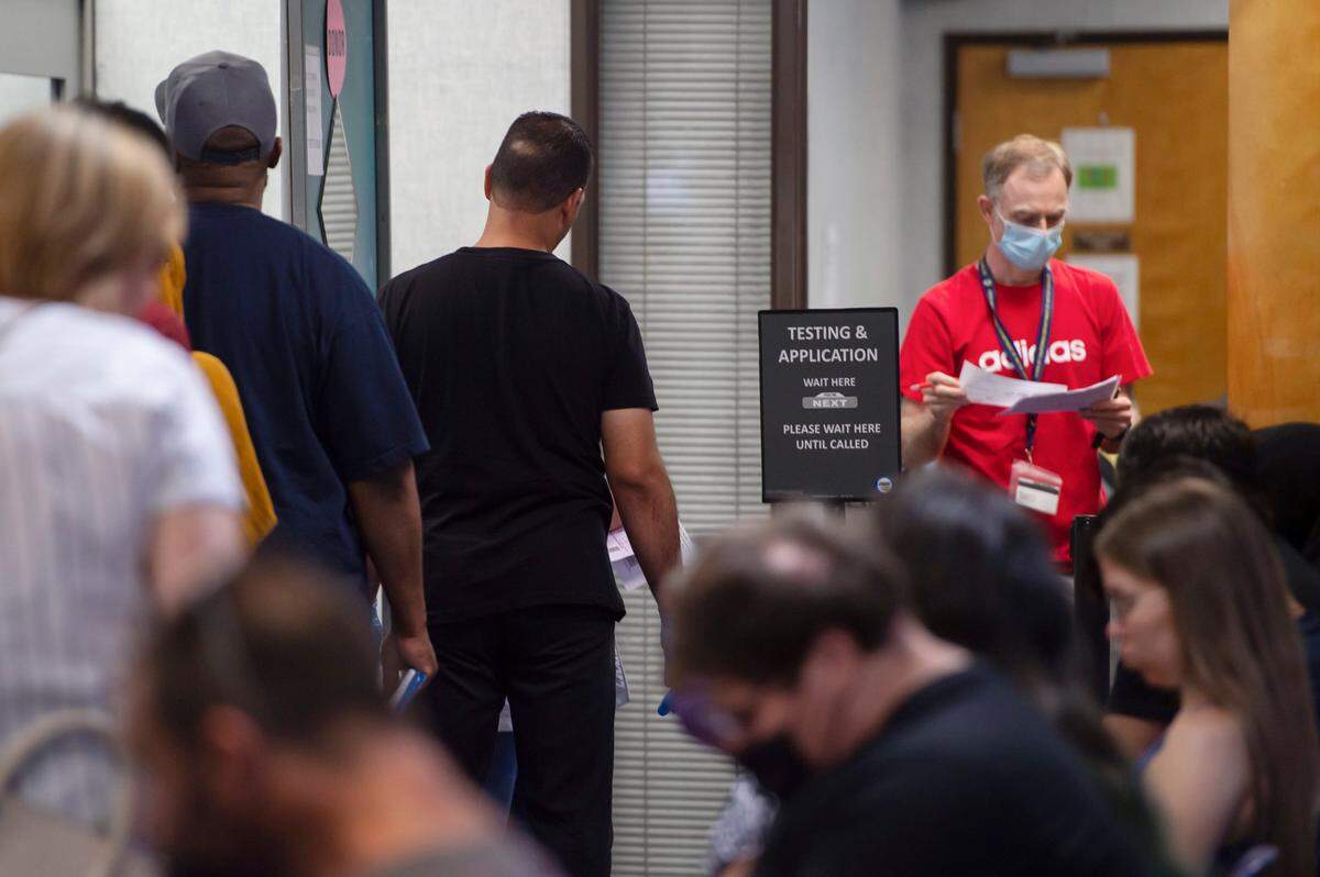 People wait in line to take a driver’s test at the Broadway DMV in Sacramento on Monday, June 27, 2022.