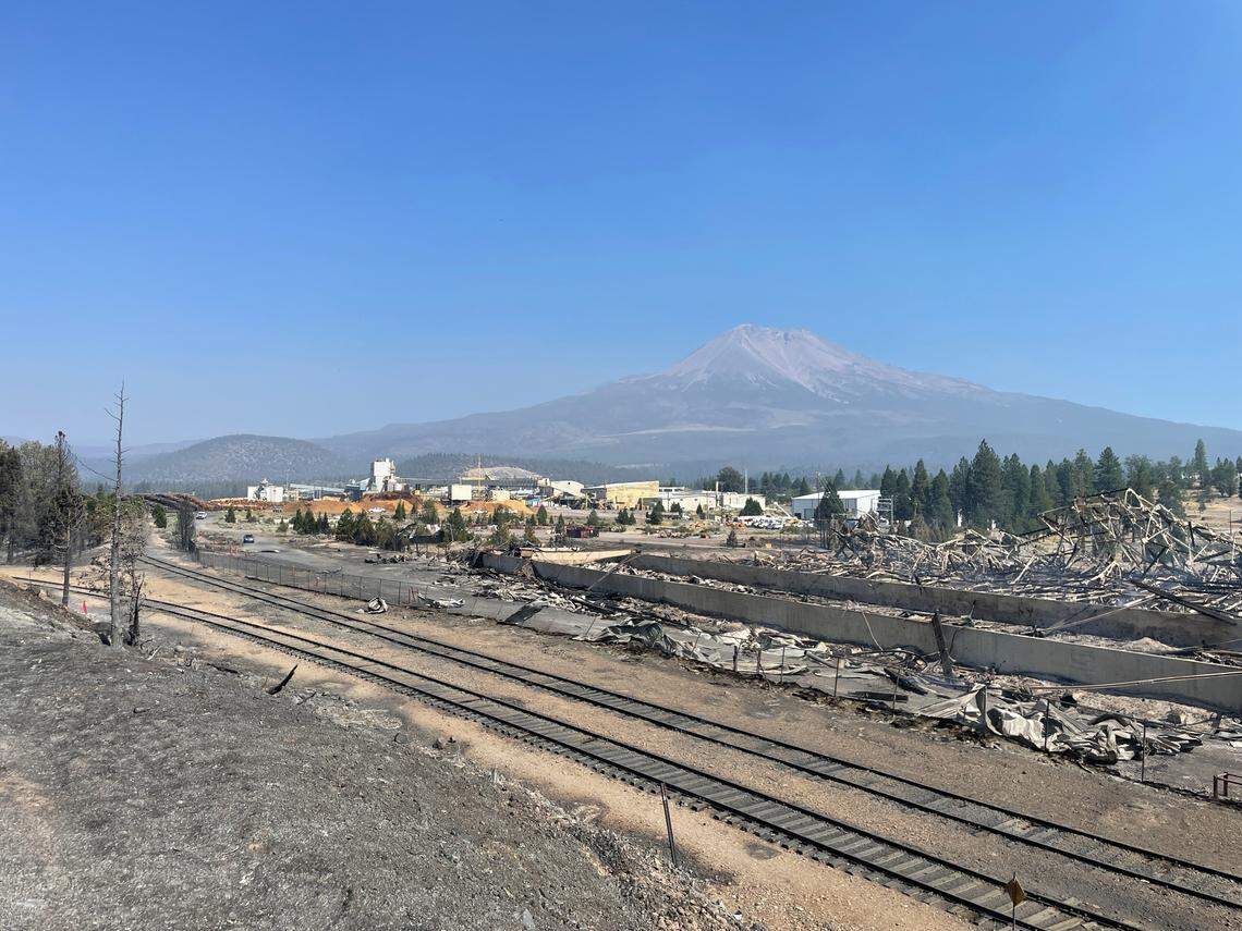 A destroyed warehouse smolders Saturday, Sept. 3, 2022, on Roseburg Forest Products property in Weed, Calif., one day after the Mill Fire burned through the adjacent Lincoln Heights neighborhood.